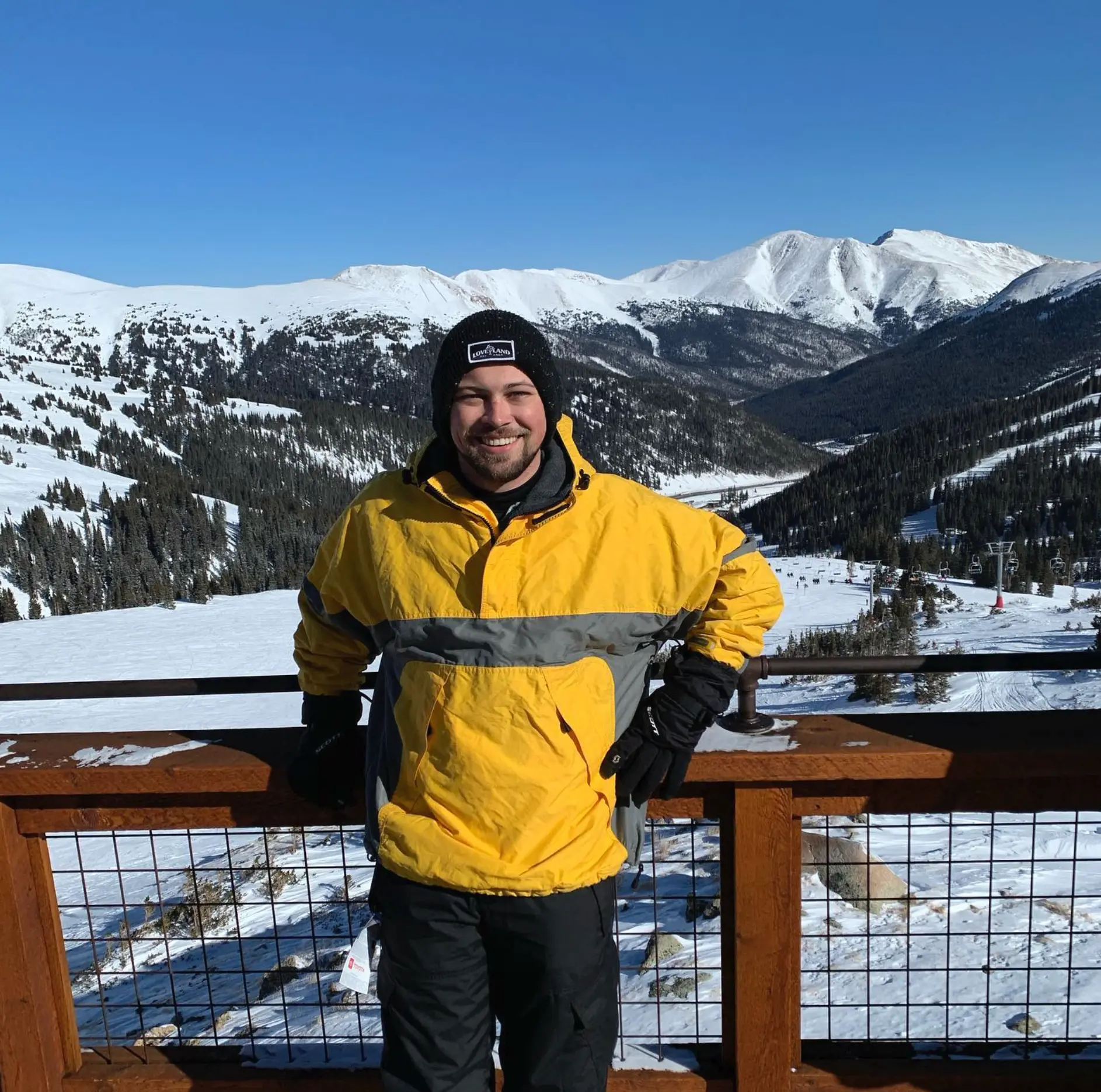Nick Holloway smiling on a snowy mountain overlook